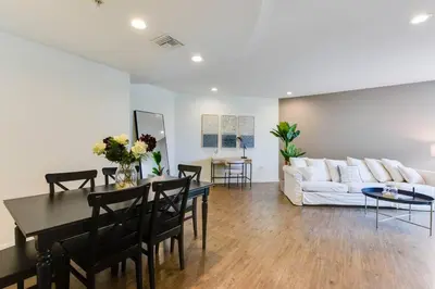 a living room with a table and a couch at Lavish Living Lux Marina Views in Los Angeles