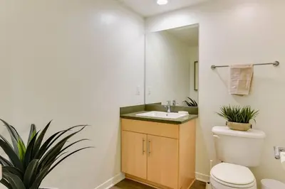 a bathroom with a white toilet and a sink at Lavish Living Lux Marina Views in Los Angeles