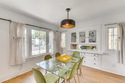 a dining room with a glass table and chairs at 7 Mi to DTLA! Family Home with Furnished Deck in Los Angeles