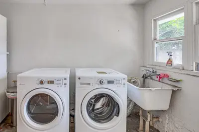 a laundry room with a washing machine and a sink at 7 Mi to DTLA! Family Home with Furnished Deck in Los Angeles