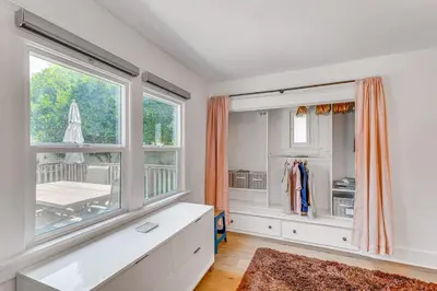 a large white room with a window and a table at 7 Mi to DTLA! Family Home with Furnished Deck in Los Angeles