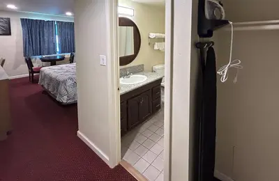 a bathroom with a sink and a mirror at Studio 6 Suites Santa Ana, CA in Santa Ana