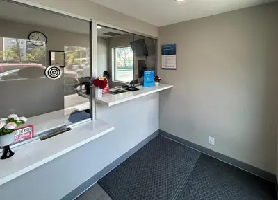 a waiting room with a counter and a window at Studio 6 Suites Santa Ana, CA in Santa Ana