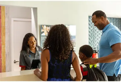 a group of people standing in front of a mirror at Studio 6 Suites Santa Ana, CA in Santa Ana