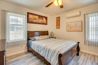 a bedroom with a bed and two windows at 2 Mi to SoFi Stadium Updated Inglewood Home! in Los Angeles
