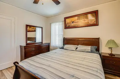 a bedroom with a large bed and a mirror at 2 Mi to SoFi Stadium Updated Inglewood Home! in Los Angeles
