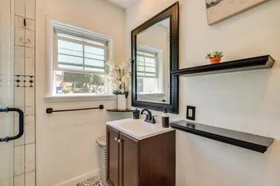 a bathroom with a sink and a mirror at 2 Mi to SoFi Stadium Updated Inglewood Home! in Los Angeles