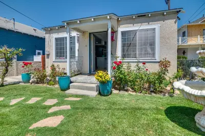 a house with flowers in the yard at 2 Mi to SoFi Stadium Updated Inglewood Home! in Los Angeles