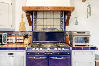 a kitchen with a blue stove and a sign on the wall at Hollywood Hills Walk to Universal City Views in Los Angeles