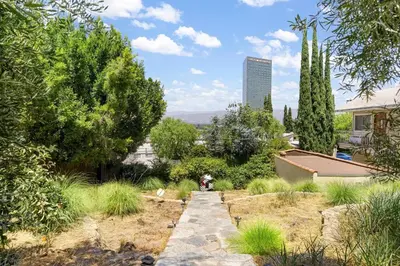 a garden with a stone path and trees at Hollywood Hills Walk to Universal City Views in Los Angeles
