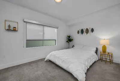 a white bedroom with a bed and a window at Amazing, Spacious Unit, Heart LA in Los Angeles