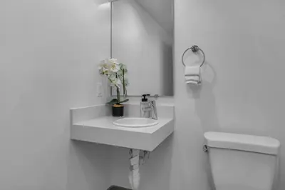 a white bathroom with a sink and a toilet at Amazing, Spacious Unit, Heart LA in Los Angeles