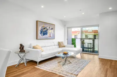 a living room with a white couch and a table at Amazing, Spacious Unit, Heart LA in Los Angeles