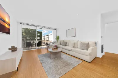 a living room with a couch and a table at The Orchid-Beachfront Bliss Spacious 2BR Apt In Santa Monica in Los Angeles