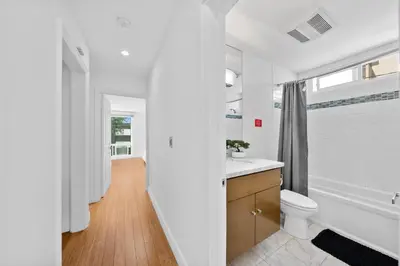 a white bathroom with a toilet and a sink at The Orchid-Beachfront Bliss Spacious 2BR Apt In Santa Monica in Los Angeles