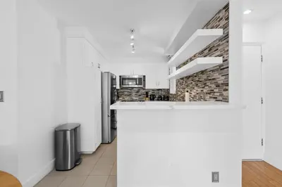 a kitchen with white walls and a counter top at The Orchid-Beachfront Bliss Spacious 2BR Apt In Santa Monica in Los Angeles
