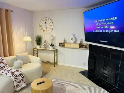 a living room with a tv and a fireplace at Mid-City Charm 2BR Near LAs Hotspots! in Los Angeles