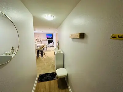 a hallway with a mirror and a dining room at Mid-City Charm 2BR Near LAs Hotspots! in Los Angeles