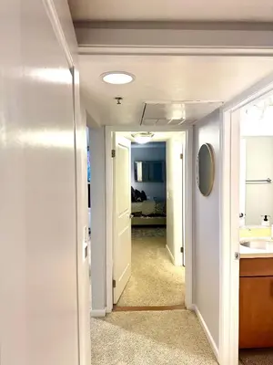 a hallway with a bathroom and a sink in a room at Mid-City Charm 2BR Near LAs Hotspots! in Los Angeles