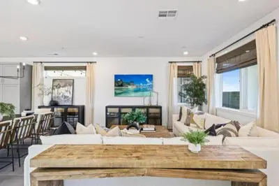 a living room with white furniture and a wooden table at Luxury 4 bedroom house Los Angeles in Castaic Junction