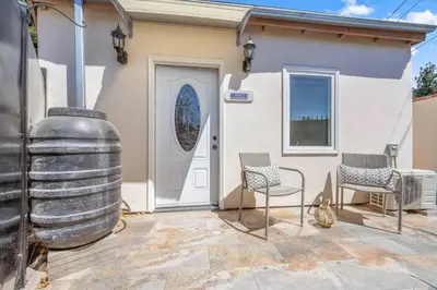 a house with a large wine barrel and two chairs at Woodland Victory Hideaway in Tarzana