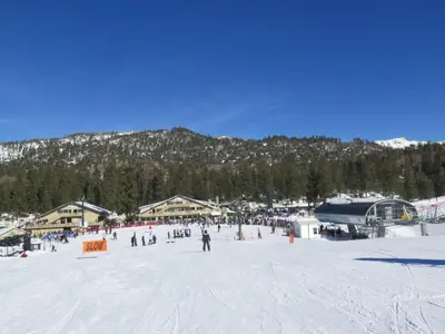 a group of people skiing on a snow covered slope at Bugsy's Hideout in Lake Arrowhead
