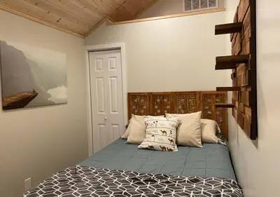 a bedroom with a bed with a wooden headboard at Bugsy's Hideout in Lake Arrowhead