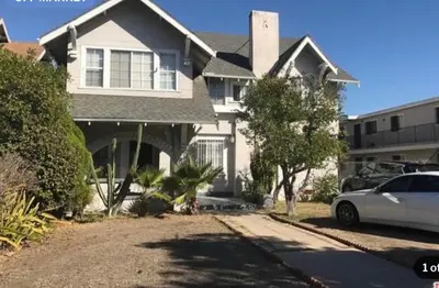 a white car parked in front of a house at Spacious Chic 5 Bedroom Perfect for Large Group With parking in Los Angeles