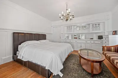 a bedroom with a large bed and a chandelier at Spacious Chic 5 Bedroom Perfect for Large Group With parking in Los Angeles