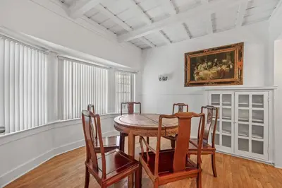 a dining room with a wooden table and chairs at Spacious Chic 5 Bedroom Perfect for Large Group With parking in Los Angeles