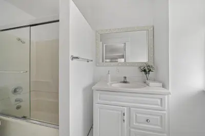 a white bathroom with a sink and a shower at Spacious Chic 5 Bedroom Perfect for Large Group With parking in Los Angeles