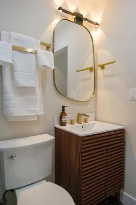 a bathroom with a toilet and a sink and a mirror at Adobe Inn in Monterey Park