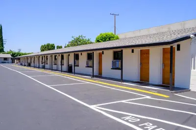 an empty parking lot in front of a building at Adobe Inn in Monterey Park