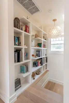 a library with white bookshelves and a chandelier at Walk to Venice Beach from Luxury home in Los Angeles