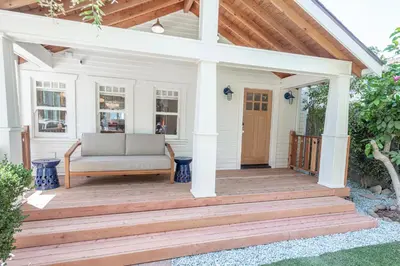 a porch with a couch on a wooden deck at Walk to Venice Beach from Luxury home in Los Angeles