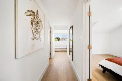 a hallway with white walls and a bedroom with a bed at 2Bedroom home - Marengo Estate in Alhambra