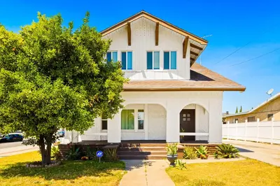 a white house with a tree in front of it at 2Bedroom home - Marengo Estate in Alhambra