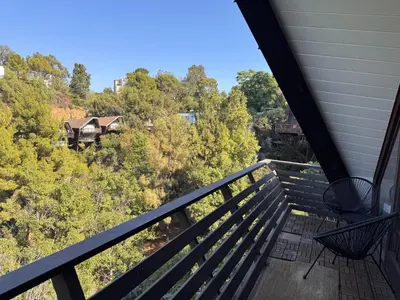 a balcony with a view of the woods at Architectural Marvel in Hollywood Hills with Views in Los Angeles