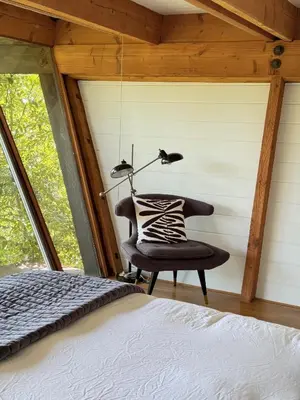 a bedroom with a bed and a lamp at Architectural Marvel in Hollywood Hills with Views in Los Angeles
