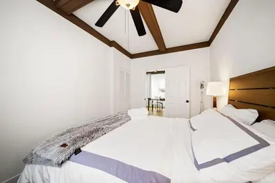 a bedroom with a large white bed with a ceiling fan at 2Bedroom home for your comfort and relaxation in Alhambra