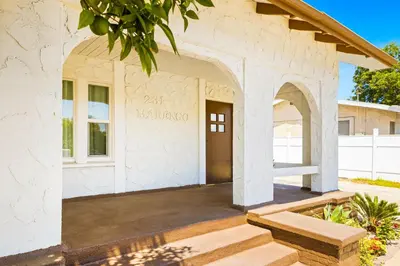 a home with a stone building with a porch at 2Bedroom home for your comfort and relaxation in Alhambra