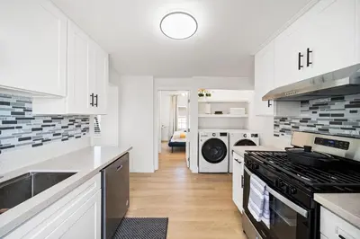 a kitchen with white cabinets and a stove top oven at 2Bedroom home for your comfort and relaxation in Alhambra