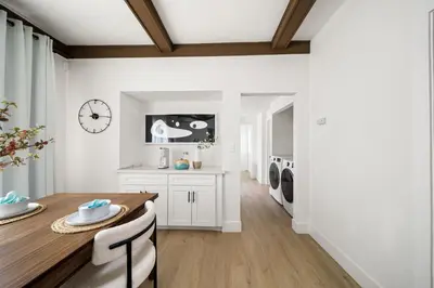 a kitchen with a dining table and a laundry room at 2Bedroom home for your comfort and relaxation in Alhambra