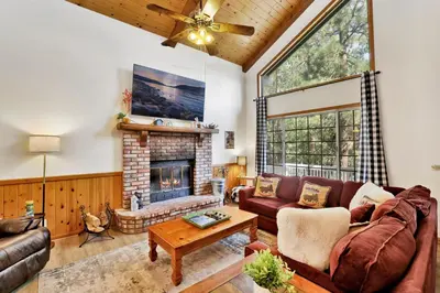 a living room with a couch and a fireplace at Four little bears cabin #2490 in Big Bear Lake
