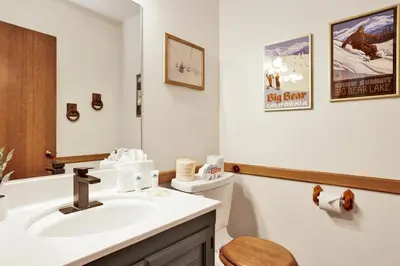 a bathroom with a sink and a toilet and a mirror at Four little bears cabin #2490 in Big Bear Lake
