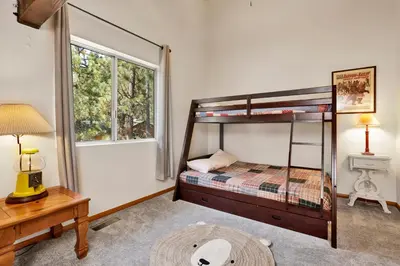 a bedroom with two bunk beds and a window at Four little bears cabin #2490 in Big Bear Lake