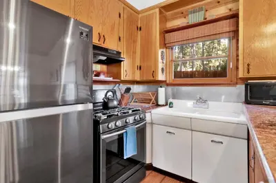 a kitchen with a stainless steel stove and a sink at The nest on towne trail #2480 in Big Bear Lake