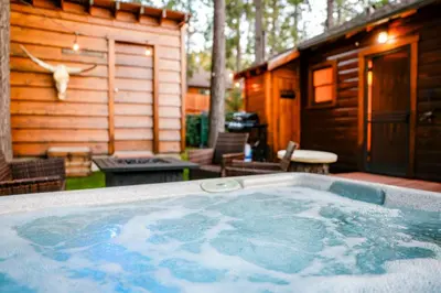 a large hot tub in front of a cabin at The nest on towne trail #2480 in Big Bear Lake