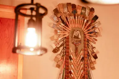 a clock hanging on a wall with a light at The nest on towne trail #2480 in Big Bear Lake