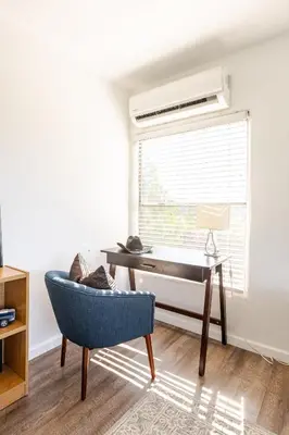 a living room with a desk and a chair and a window at Serene and beautiful hillside retreat in Glendale
